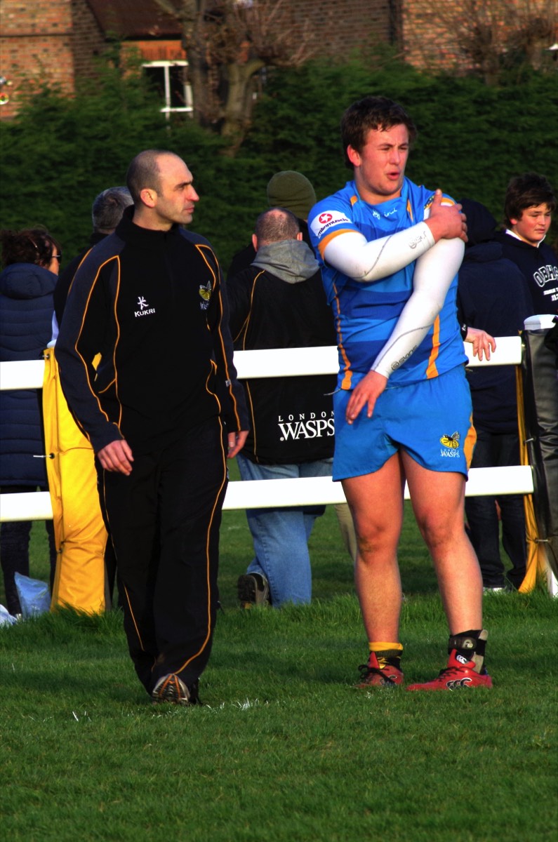 Ben coaching a young Wasps player on the touchline